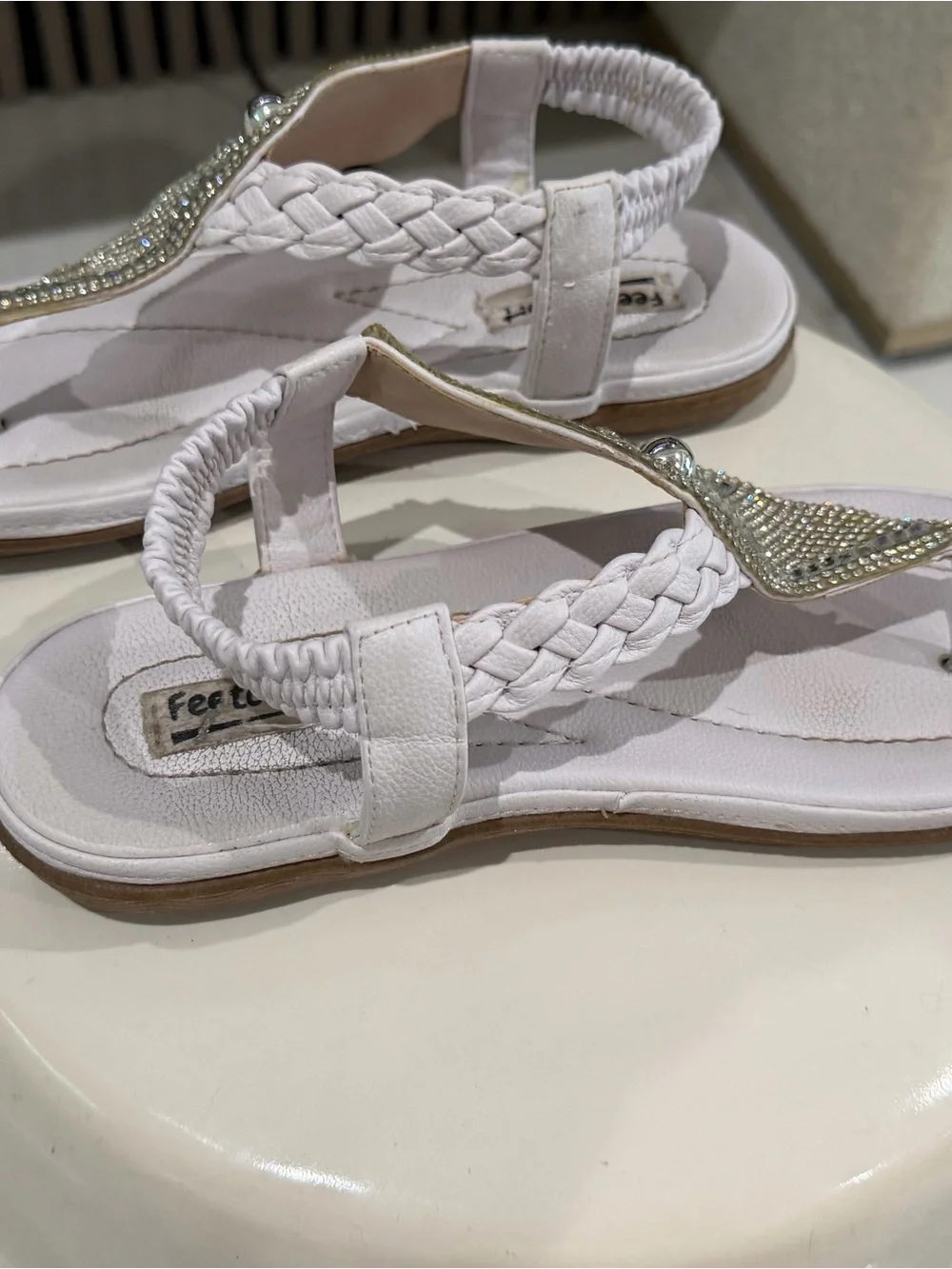 White rhinestone sandals with braided straps.